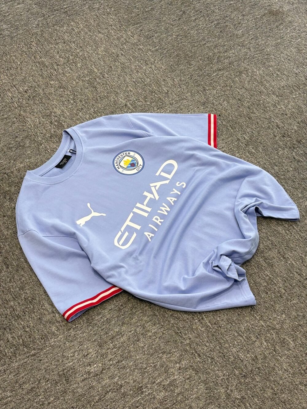 Manchester City Light Blue Soccer Oversized T-Shirt with Red-Striped Sleeves