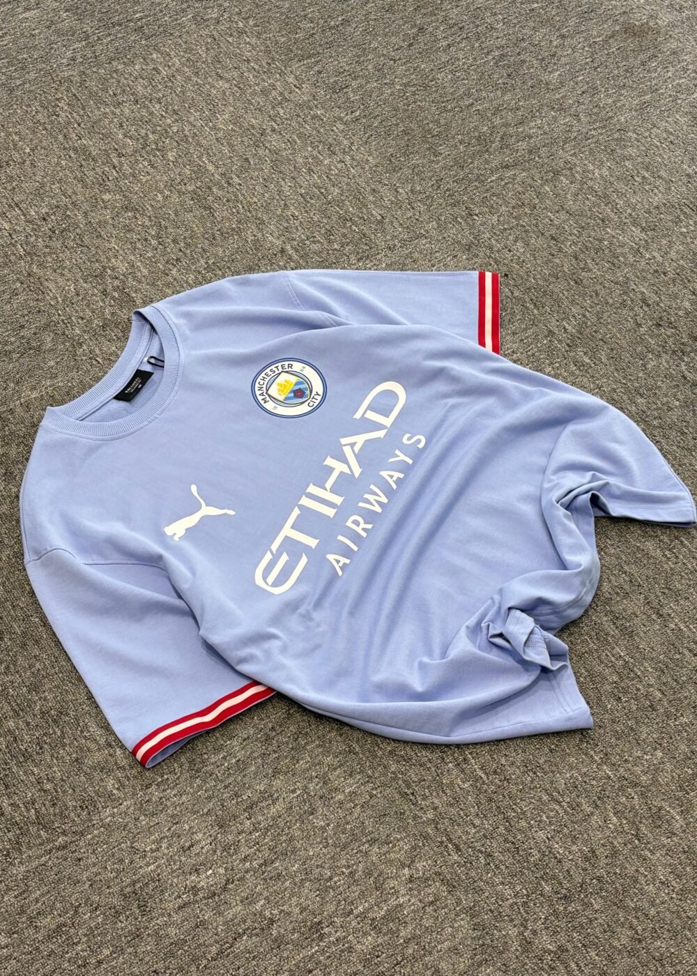 Manchester City Light Blue Soccer Oversized T-Shirt with Red-Striped Sleeves
